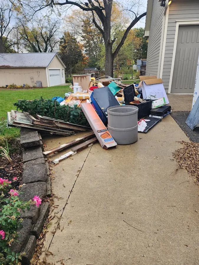 Dumpster being loaded with debris for Estate Cleanout Dumpster Rental in Hingham